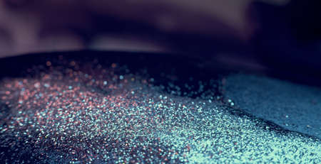 Liquid glitter motion. Defocused blue pink purple sparkling wet flakes floating. Abstract background shot on RED Cinema camera.の写真素材