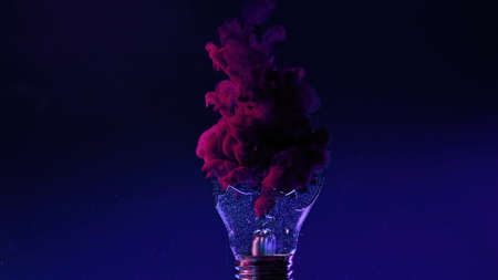 Ink water shot. Light bulb explosion. Fantasy splash. Neon magenta pink smoke cloud in broken lamp...