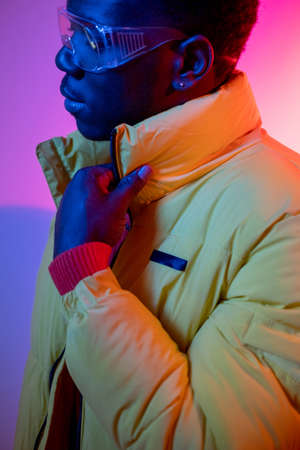 Urban guy. Street wear. Male fashion. Vivid neon. Stylish confident young man portrait in casual...