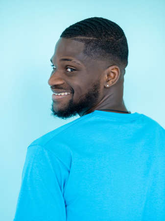 Smiling man. Happy portrait. Optimistic emotion. Joyful toothy positive beardy guy face headshot isolated on blue studio background.の写真素材