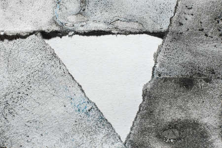 Copy space for logo. Old paper background. Grunge frame. Black blue paint grain stains on white uneven ripped edge abstract art texture with blank center triangle for text.の写真素材