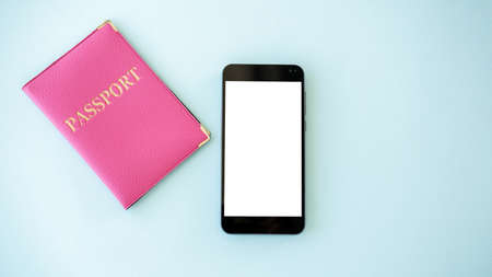 Online visa. Digital mockup. Mobile technology. Smartphone with white blank screen and pink foreign passport isolated blue copy space.の写真素材