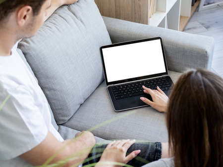 Online conference. Computer mockup. Home rest. Unrecognizable man and woman choosing film on laptop...