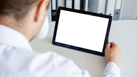 Distance education. Computer mockup. Online conference. Unrecognizable man looking tablet computer...