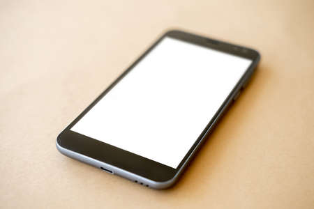 Mobile technology. Digital mockup. Online connection. Smartphone with white blank screen laying...