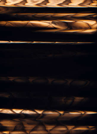 Grunge overlay. Glitch texture. Bad signal defect. Orange black color stitched textile noise on dark illustration abstract background.の写真素材