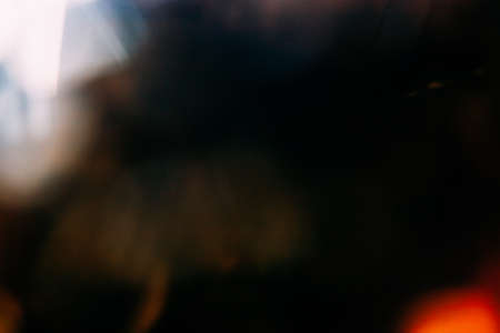 Lens flare overlay. Bokeh light. Blur radiance. Defocused orange golden white color glow on dark...