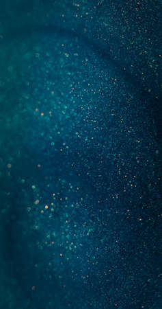 Particles texture background. Blur glitter flare. Bokeh sparkles. Defocused blue orange color shimmering dust on dark abstract overlay.の写真素材