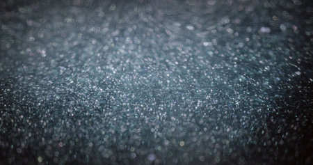 Particles background. Blur grain texture. Bokeh light flare. Defocused purple white sparkles on dark...