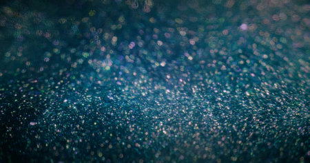 Blur sparkles background. Color bokeh circles. Glamour light flare. Defocused fluorescent purple blue particles texture on dark abstract poster.の写真素材