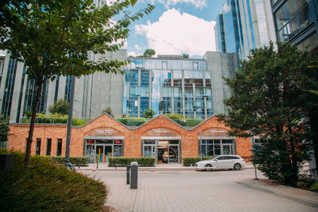 Warsaw, Poland - June 27, 2022: Car manufacturing. City industry. Business center. Street road with famous Volkswagen factory building in daylight.のeditorial素材