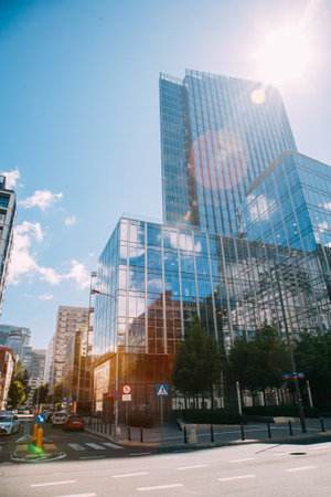 Warsaw, Poland - June 22, 2022: City landmark. Modern street. Futuristic Europe. Glassy buildings with crosswalk road in sunlight day view lens flare.のeditorial素材