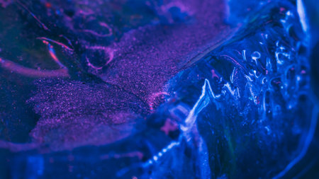 Blue paints on melting ice. Flowing liquid inks. Nature glacier. Creative art processの写真素材