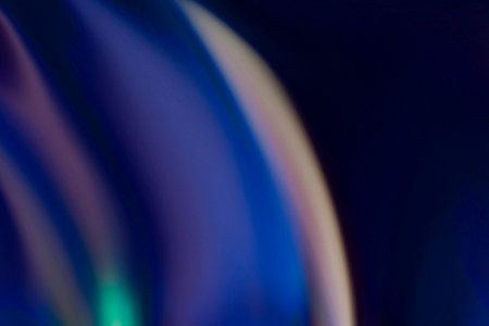 Blur neon glow. Light flare. Futuristic radiance. Defocused fluorescent blue orange purple color glare on dark abstract empty space background.の写真素材