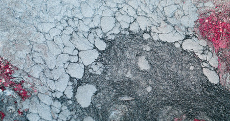 Winter frost abstract background. Ice texture. Snow particles. Red white silver gray color grain...
