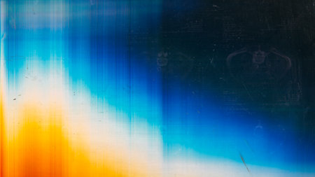 Dust scratch overlay. Light flare. Old film texture. Orange blue white rainbow color glow defect dirt stains on dark abstract empty space background.の写真素材