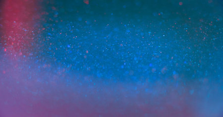 Neon glitter texture. Bokeh light flare. Shimmering sequin glare. Defocused blue pink color sparkling circles glow lens flare abstract background with free space.の写真素材