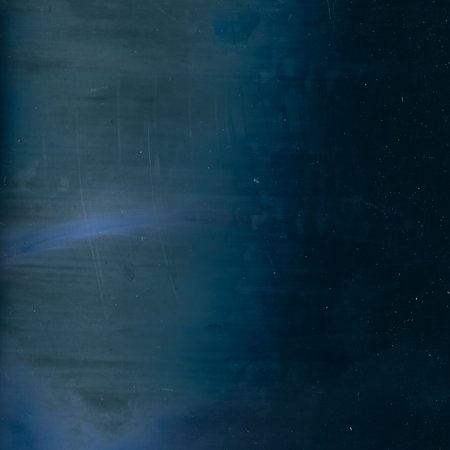 Weathered film. Worn texture. Distressed overlay. Blue flare dirt stains dust scratches on dark grunge illustration abstract background.の写真素材
