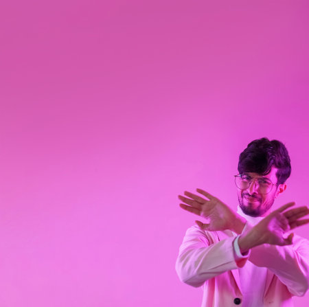 No gesture. Stop enough. Refusal restriction. Pink color neon light displeased disgusted annoyed man rejecting offer with crossed hands on empty space background.の写真素材