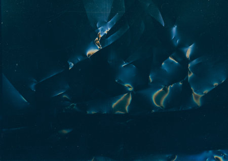 Grunge texture. Distressed film. Used surface. Blue orange color flare dust scratches noise on dark crushed abstract illustration background.の写真素材
