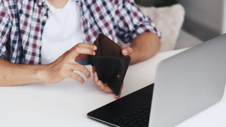 Internet scam. Online fraud. Freelance work risk. Unrecognizable broke poor man hands revealing...