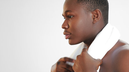Morning freshness. Spa therapy. Hygiene wellness. Closeup profile portrait of confident man with clean face skin towel after shower on white empty space background.の写真素材