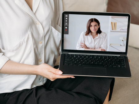 Video interview. Web chat. Remote communication. Virtual meeting. Confident business women working online on laptop screen at digital office.の写真素材