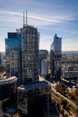 Warsaw, Poland - September 7, 2022: City landscape. Skyscraper view. Downtown center. High building with glass facade office architecture on blue sky.のeditorial素材