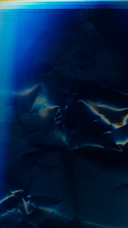 Distressed overlay. Light flare noise. Old film texture. Blue orange color uneven creased surface...