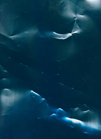 Dust scratches overlay. Creased texture. Old film defect. Blue white color distressed uneven surface dark illustration abstract background.の写真素材