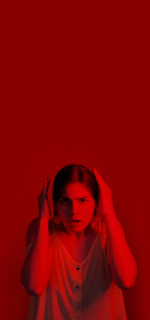 Scared woman portrait. Frightened emotions. Stressed neon color light girl covering ears problems...