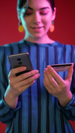 Distance paying. Online shopping. Satisfied neon color light girl internet purchase mobile phone...
