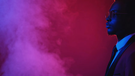 Man determination. Masculine confidence. Blue pink neon light profile portrait of serious gentleman in elegant suit glasses on bright dark color smoke empty space background.の写真素材