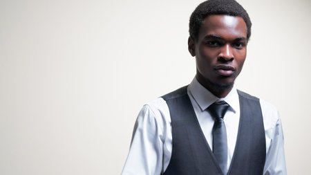 Business fashion. Gentleman style. Smart casual look. Portrait of confident man wearing shirt vest tie isolated on white empty space background.の写真素材