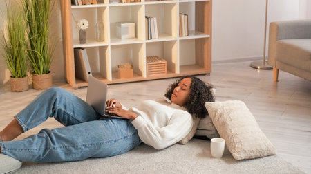 Internet browsing. Laptop leisure. Home relax. Peaceful woman surfing online on netbook enjoying...