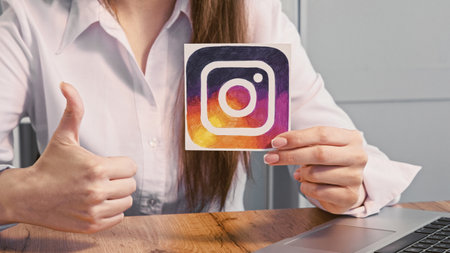 Kharkiv, Ukraine - May 13, 2020: Instagram icon. Social media. Unrecognizable business woman hands...