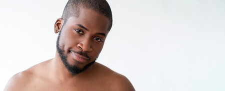 Man skin wellness. Facial health. Handsome satisfied shirtless guy with radiant smooth face perfect beard hair smiling isolated on white background empty space.の写真素材