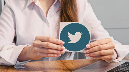 Kharkiv, Ukraine - May 13, 2020: Twitter icon. Social media. Unrecognizable woman hands presenting internet network logo.のeditorial素材