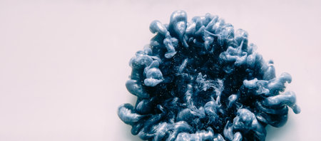 Ink splash background. Explosion cloud. Hypnotic steel gray glitter burst smoke spreading in dynamic abstract art isolated on white empty space.の写真素材