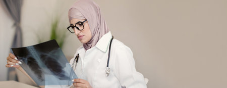 Radiology diagnostics. Healthcare professional. Medical specialist doctor woman analyzing lungs x-ray scan at hospital office workplace copy space.の写真素材