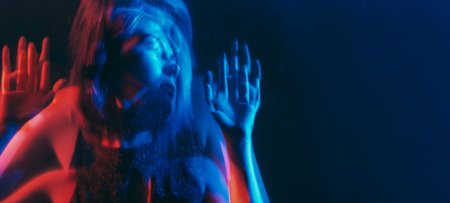 Anxiety disorder. Defocused silhouette. Depressed worried woman mental health mixed neon blue red...
