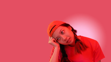Daydreaming girl. Idea inspiration. Creative imagination. Neon light pensive hipster teenager thinking isolated on pink empty space background.の写真素材