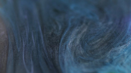 Glitter texture. Sparkling flow. Defocused blue shiny dark silver color mixes shimmering particles ink abstract background art design.の写真素材