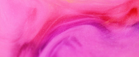 Glitter oil. Shiny paint. Defocused pink red color flowing translucent drop emulsion sparkling particles beauty ink gel texture abstract art background.の写真素材