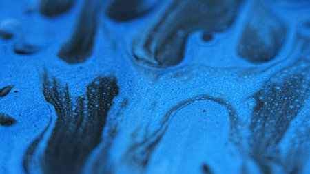 Shiny paint. Bubble drop spill. Brilliance ink. Defocused blue white black color moving glowing fluid flow glossy glitter gel blend abstract art background.の写真素材
