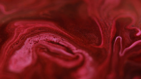 Glitter fluid mix. Paint spill. Defocused red pink color shimmering particles liquid emulsion blend flow abstract art background.の写真素材