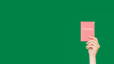Passport document. Immigration service. Female hand showing citizenship ID in pink cover isolated on...