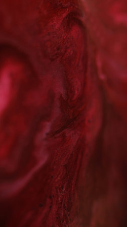 Paint splash. Sparkling fluid. Defocused red pink color glitter particles texture emulsion wave abstract art background.の写真素材