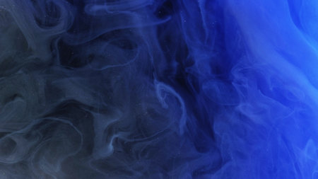 Blur mist cloud. Paint water splash. Defocused blue color glowing dust particles texture haze floating on dark black abstract art background.の写真素材