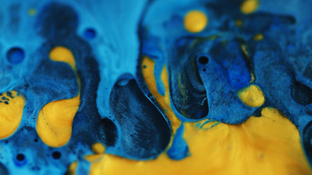 Wet glitter blend. Acrylic fluid. Defocused blue yellow golden color shimmer spill liquid oil drop...